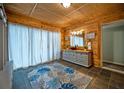 Spacious bathroom with wood paneling, stylish vanity, and large window with soft lighting at 4297 Earney Rd, Woodstock, GA 30188