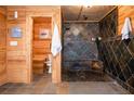 Luxurious bathroom featuring a large walk-in shower with stone tile and wood accents at 4297 Earney Rd, Woodstock, GA 30188
