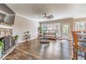 Cozy living room featuring a stone fireplace, hardwood floors, and ample natural light at 115 Greenbrier Way, Canton, GA 30114