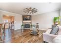 Comfortable living room with a fireplace, neutral tones, and views of connecting rooms at 115 Greenbrier Way, Canton, GA 30114