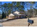 Two-story house with a large backyard and a detached garage at 1357 Ridgewood Dr, Lilburn, GA 30047