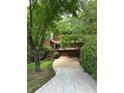 Charming home with an exterior showcasing lush greenery and a winding driveway at 3457 Winter Wood Cv, Marietta, GA 30062