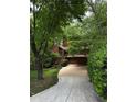 Charming home with an exterior showcasing lush greenery and a winding driveway at 3457 Winter Wood Cv, Marietta, GA 30062