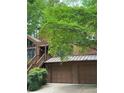 Charming home with lush landscaping, a curved driveway, and 2-car garage at 3457 Winter Wood Cv, Marietta, GA 30062