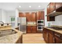 Kitchen featuring stainless steel appliances, granite countertops, and warm wood cabinetry at 424 Lindbergh Ne Dr # 111, Atlanta, GA 30305