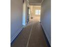Hallway view of a bright and airy living room and fireplace at 8971 Callaway Dr, Winston, GA 30187