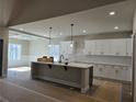 Modern kitchen features an island, white cabinetry, subway tile backsplash, and stainless steel appliances at 8971 Callaway Dr, Winston, GA 30187