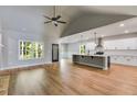 Bright, open-concept living area flowing into the kitchen, featuring hardwood floors at 8971 Callaway Dr, Winston, GA 30187