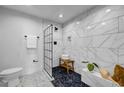 Modern bathroom with a glass-enclosed shower, marble tile, and stylish fixtures at 3180 Mathieson Ne Dr # 703, Atlanta, GA 30305
