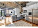 Modern kitchen with stainless steel appliances, white cabinets, and an open concept design at 3180 Mathieson Ne Dr # 703, Atlanta, GA 30305