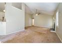 Open living room showcasing neutral tones and carpet flooring at 515 Allens Landing Ct, Lawrenceville, GA 30045