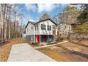 Modern house with gray and white exterior, red door, and a concrete driveway at 2343 Carver Nw Dr, Atlanta, GA 30314