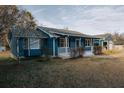 Side view of a charming blue house with white porch at 110 Fox Meadow Dr, Covington, GA 30016