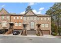 Three townhouses with brick fronts, garages, and landscaping at 2671 Willow Field Se Xing # 14, Marietta, GA 30067