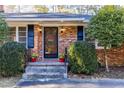 Inviting front entrance with a charming brick facade and steps at 4220 Rickenbacker Ne Way, Atlanta, GA 30342