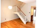 Light dining area with hardwood floors and a modern staircase at 2058 Powers Ferry Se Trce, Marietta, GA 30067