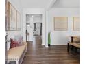 Bright entryway with hardwood floors, bench seating, and views into the living room at 8228 Walnut Hall Dr, Fairburn, GA 30213
