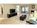 Spacious living room with a fireplace and access to a sunroom at 224 Seasons Pkwy, Norcross, GA 30093