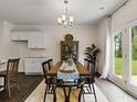 Kitchen dining area with a wooden table and access to the backyard at 8232 Walnut Hall Dr, Fairburn, GA 30213
