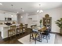Open concept kitchen with island, granite countertops, and white cabinets at 8232 Walnut Hall Dr, Fairburn, GA 30213