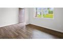 Spacious living room with hardwood floors and large window at 8234 Walnut Hall Dr, Fairburn, GA 30213