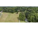House nestled in a lush forest setting at 416 Spring Place Ne Rd, White, GA 30184
