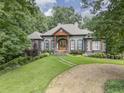 Attractive home with well-maintained landscaping, stone accents, and a welcoming front entrance at 416 Spring Place Ne Rd, White, GA 30184
