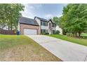 Two-story house with driveway and mature trees at 814 Sunny Field Ln, Lawrenceville, GA 30043