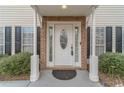 Inviting front entry featuring a white door with decorative glass, flanked by sidelights and brick accents at 814 Sunny Field Ln, Lawrenceville, GA 30043