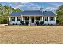 Charming home featuring a covered front porch, manicured landscaping, and a classic architectural design at 4320 Center Hill Church Rd, Loganville, GA 30052
