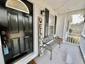 Relaxing front porch with a metal bench and string lights at 4320 Center Hill Church Rd, Loganville, GA 30052