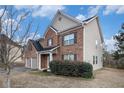 Well-maintained two-story home featuring brick and siding exterior, manicured landscaping, and attached two-car garage at 436 Margaux Way, Atlanta, GA 30349