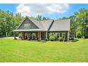 Charming single-Gathering home with covered front porch, manicured lawn, and attractive landscaping at 764 Little Vine Church Rd, Villa Rica, GA 30180