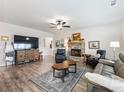 Spacious living room with hardwood floors and fireplace at 1018 Cherry Bark Ln, Loganville, GA 30096