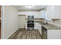 Modern kitchen featuring stainless steel appliances, ample cabinet space, and stylish flooring at 5925 S Quail Dr, Douglasville, GA 30135