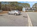 Parking area with cars parked and surrounding trees at 6406 Abercorn St, Union City, GA 30291