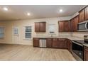 Bright kitchen with stainless steel appliances, granite countertops, and wood-look floors at 148 Oliver Dr, Locust Grove, GA 30248