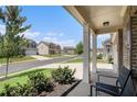 Covered porch with seating, overlooking a quiet residential street at 435 Auburn Crossing Dr, Auburn, GA 30011