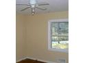 Bright bedroom featuring hardwood floors, natural light, and a ceiling fan at 1634 Willis Mill Sw Rd, Atlanta, GA 30311