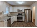 Modern kitchen with stainless steel appliances and granite countertops at 404 Utoy Sw Cir, Atlanta, GA 30331