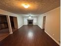 Living room with hardwood floors, a fireplace, and access to the kitchen at 6871 Lakeshore Dr, Douglasville, GA 30135