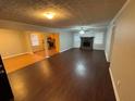 Open concept living room and dining area with hardwood floors and a fireplace at 6871 Lakeshore Dr, Douglasville, GA 30135