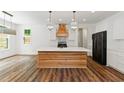 Modern kitchen with white cabinets, large island, and wood countertops at 153 Palisade Dr, Rydal, GA 30171