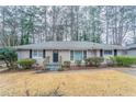 Inviting single-story house with a brick exterior, front lawn, and a cozy entryway steps at 2534 Ben Hill Rd, Atlanta, GA 30344