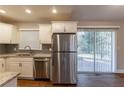 Kitchen featuring stainless steel appliances, granite counters, access to the backyard, and a light-filled space at 3080 Santa Monica Dr, Decatur, GA 30032