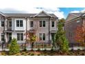 Brick townhome with black fence and landscaping at 620 Goldsmith Ct # 107, Johns Creek, GA 30022