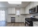 Renovated kitchen with white cabinets, stainless steel appliances, and quartz countertops at 5725 Twain Dr, Ellenwood, GA 30294