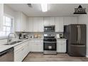Renovated kitchen with white cabinets, stainless steel appliances, and quartz countertops at 5725 Twain Dr, Ellenwood, GA 30294