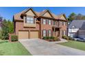 Brick home with a three-car garage and a well-maintained front yard at 1400 Cresthaven Ln, Lawrenceville, GA 30043