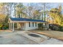 Single-story home featuring a covered carport and long driveway; lovely curb appeal at 1927 Cindy Dr, Decatur, GA 30032